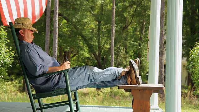 Image result for Man resting in porch on rocking chair with beer